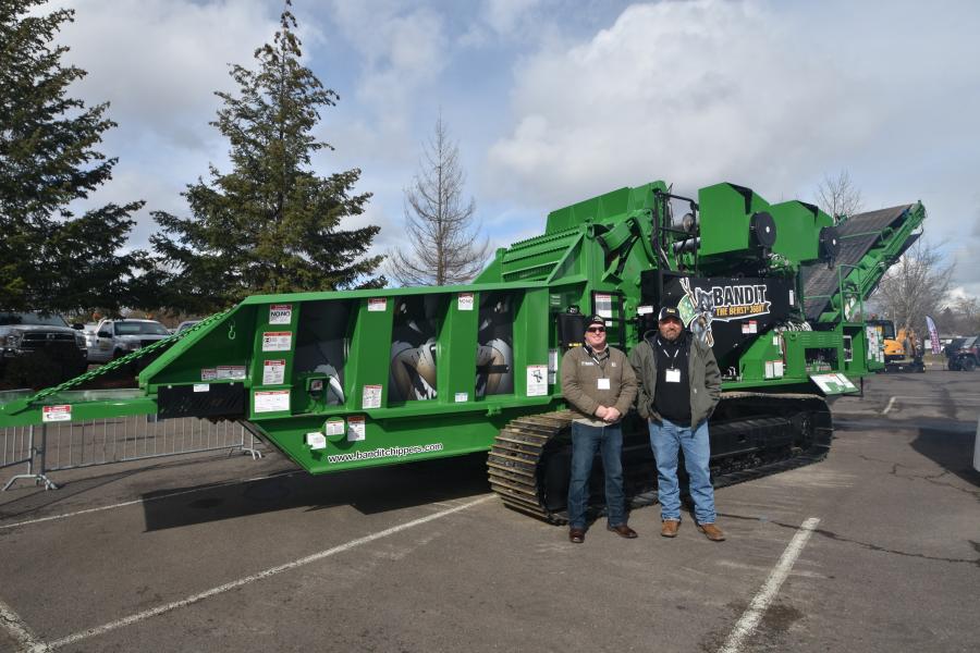 Dustin Powell (L), industrial sales territory manager of Bandit Industries Inc.; and Clint Henry, service tech of Bandit Industries Inc., with the Beast model 3680T horizontal grinder from Bandit.
(CEG photo)