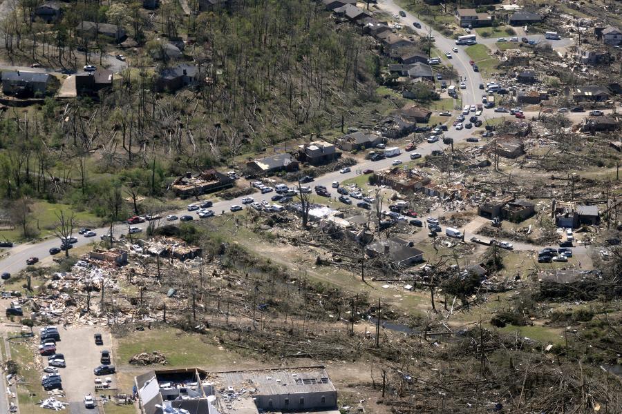 Cars line up along the road as cleanup continued April 2, 2023, from tornado damage on March 31, 2023, in west Little Rock, Ark. (Thomas Metthe/Arkansas Democrat-Gazette via AP)