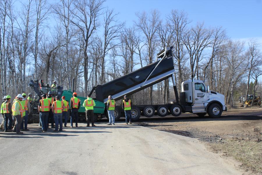 A truck from Anderson Brothers loads up the paver with material.
(CEG photo)