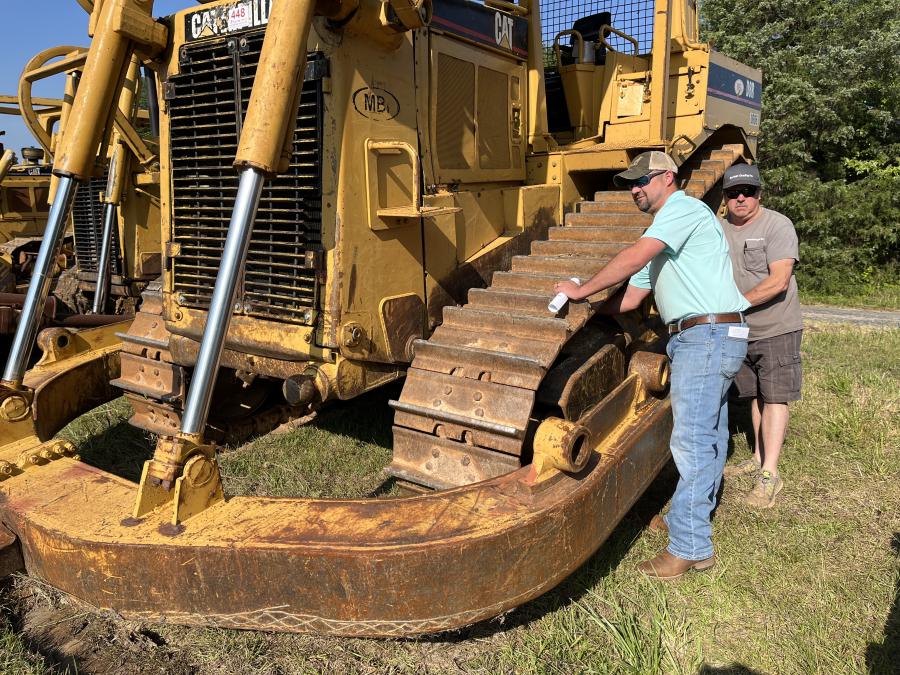 A.J. (L) and Alan Barfield, both of Garfield Grading in Ft. Mill, S.C., inspect the undercarriage of a Cat D8R. They needed a machine like this for a current project.
(CEG photo)