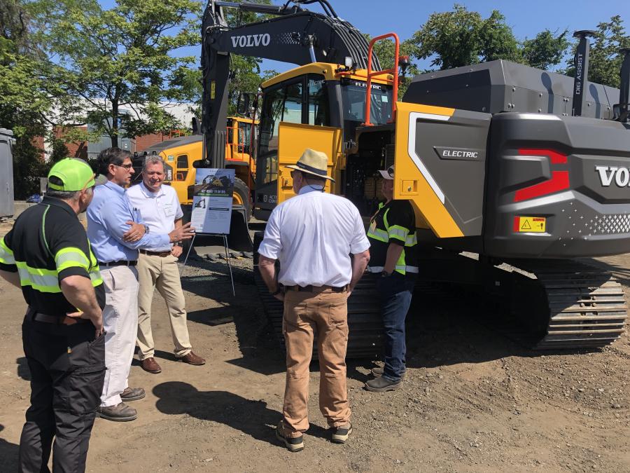 Tim Watters (third from L), president of Hoffman Equipment, speaks with customers about the Volvo EC230 electric midsize excavator.
(CEG photo)