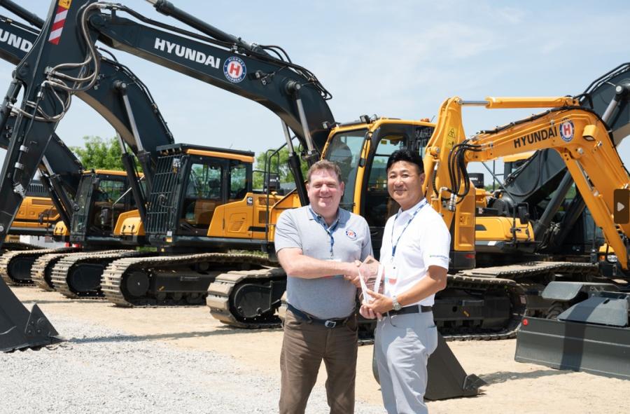 Thom Reynolds (L), president of Highway Equipment Company, and Stan Park, president of HD Hyundai Construction Equipment Americas, celebrate Highway Equipment’s 15th year anniversary as a Hyundai dealership.