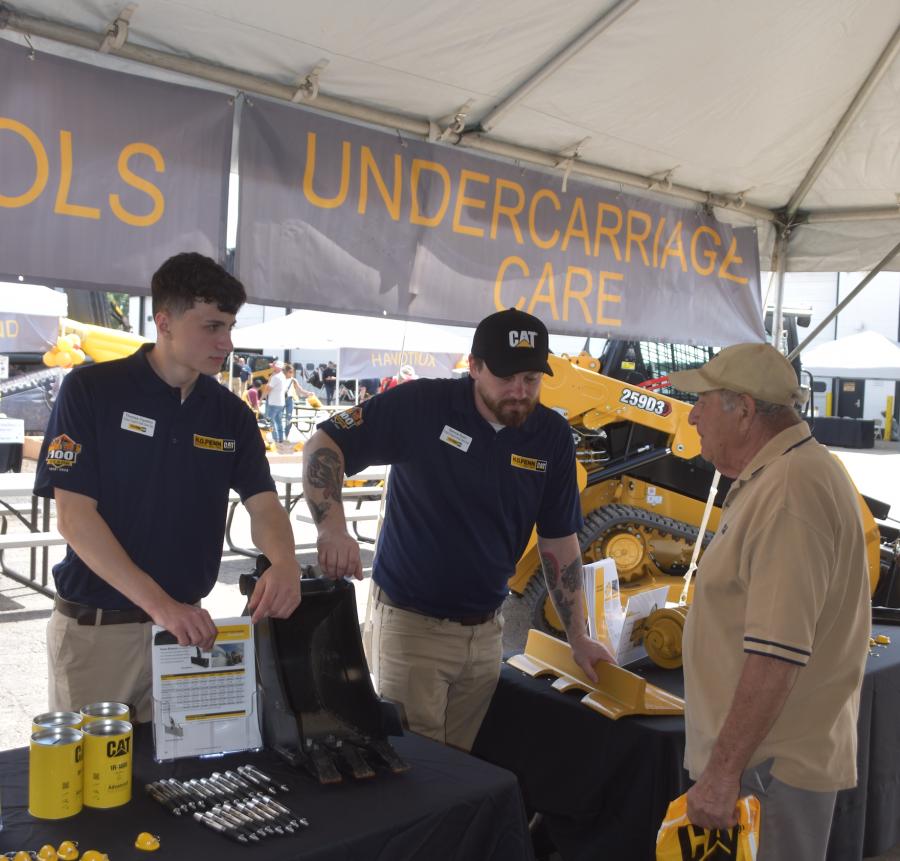 Every aspect of H.O. Penn’s Caterpillar offerings was represented at this event.  Here, H.O. Penn employees discuss a customer’s undercarriage needs.
(CEG photo) 