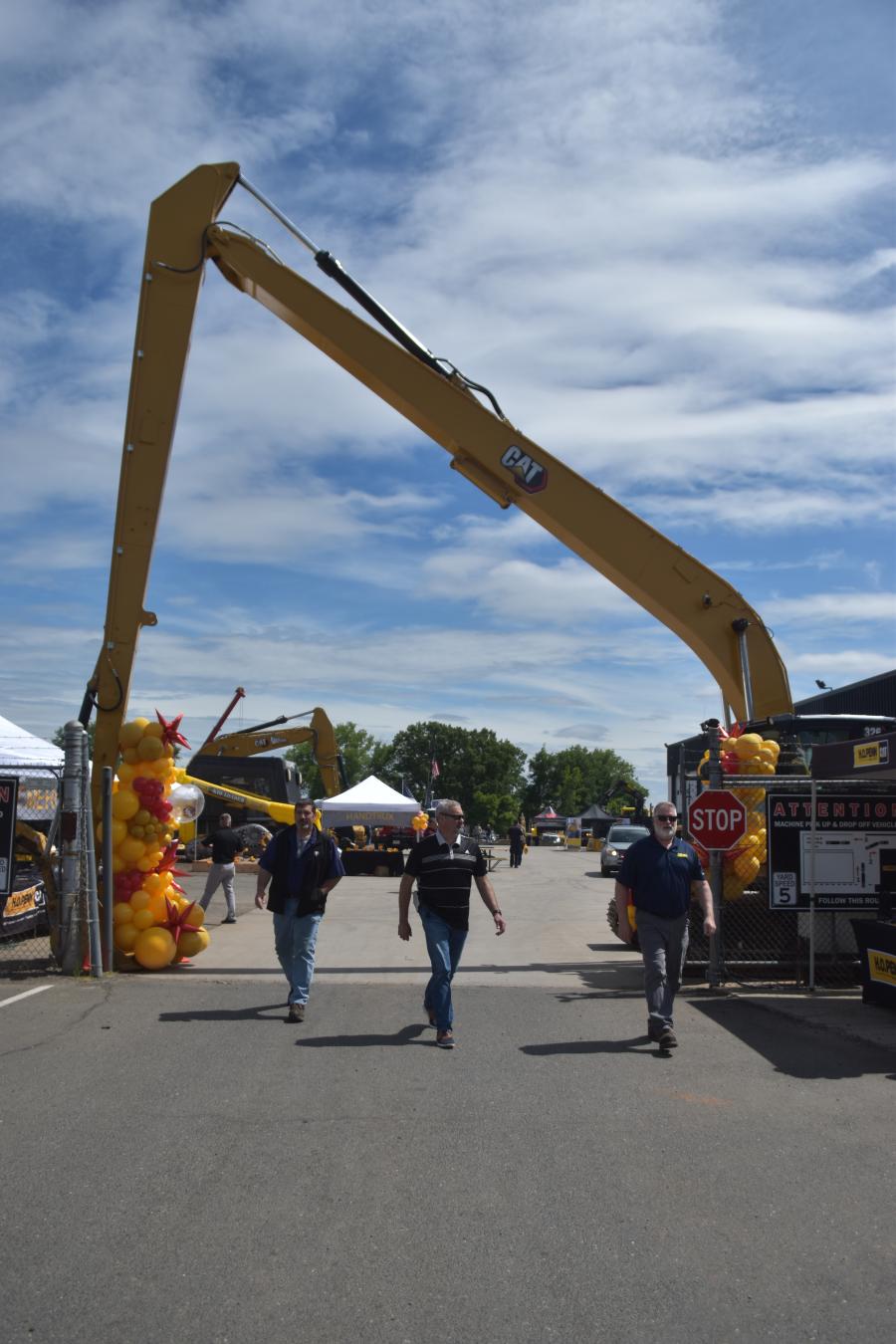 A Caterpillar long-reach excavator provides the perfect welcoming arch for guests as they arrive.
(CEG photo) 