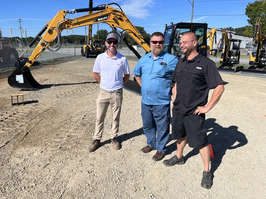 (L-R): Joe Gonzalez and Mike Windsor, both of Leica Geosystems, discuss the Leica product line with Kent Howell of Dawn Development in Monroe, N.C.
(CEG photo)