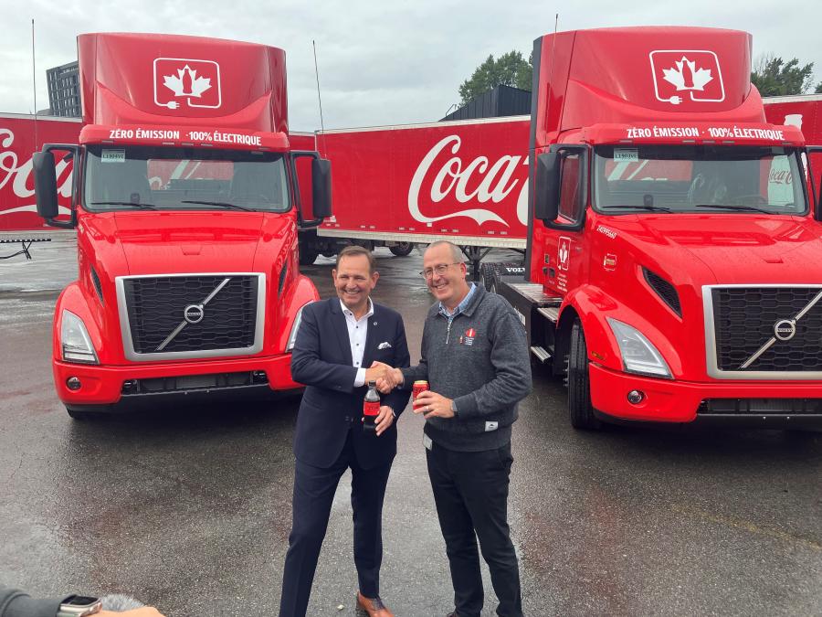Volvo Trucks North America President Peter Voorhoeve (L) joins Stephen du Toit, president and chief operating officer of Coca-Cola Canada Bottling Limited, as the beverage manufacturer takes delivery of Volvo VNR Electric trucks.