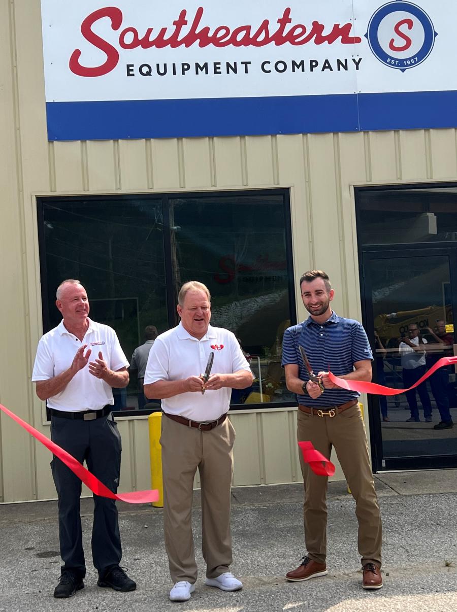 (L-R): Southeastern Equipment Company sales representative Steve McGrew applauds as South Charleston Mayor Frank A. Mullens and Southeastern Equipment Co. Executive Vice President Thor Hess cut the ribbon to kick off grand opening event.
(CEG photo)