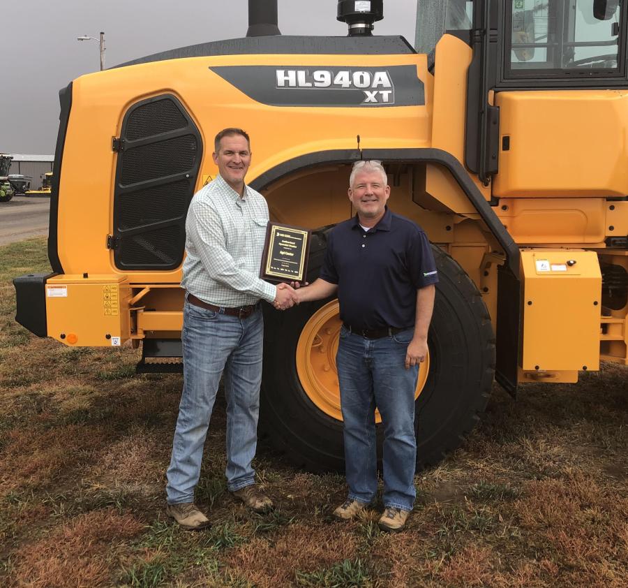 Lee File (L), co-owner, Agri Center, Hutchinson, Kan., accepts a Hyundai construction equipment dealership plaque from Ed Harseim, North Central district manager, HD Hyundai Construction Equipment North America.