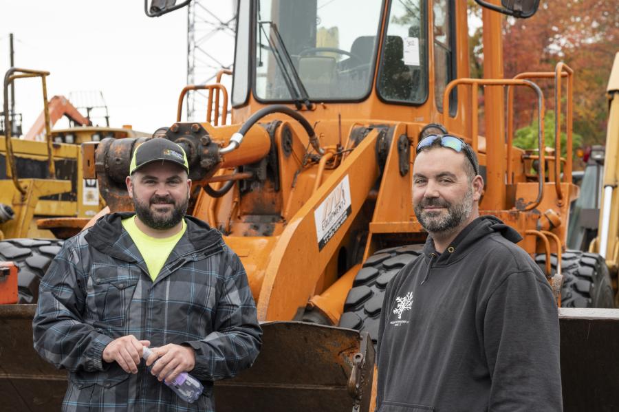 Andrew St. Jacques (L) of Four Season Landscaping in Windsor, Conn., and Tom Van Gordon of Precision Land Management in Monroe, Conn., stand with a 1990 Caterpillar 950E rubber-tire wheel loader.
(CEG photo)