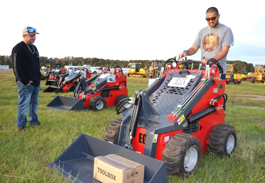 These little ride-on mini’s seemed to be all the rage at every auction and Joe Neargarder (L) and Angel Delenon of All American Land Clearing, Palm City, Fla., planned to bid on a few. 
(CEG photo)