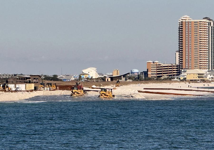 Bulldozers near Gulf State Park's Pavilion move sand pumped in from nearshore areas to bolster Alabama's beaches.