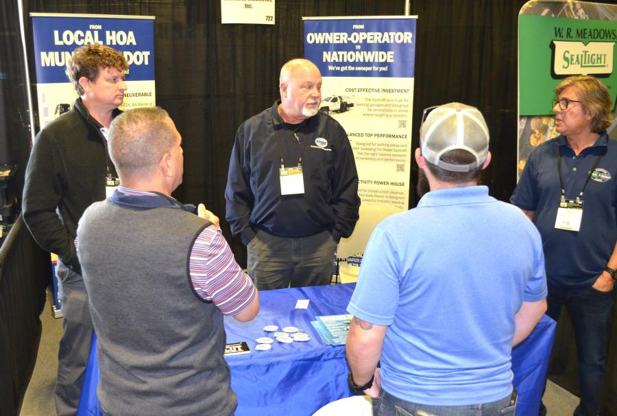 Adam Shaneyfelt (L) and Clark Word of Schwarze Industries, based in Huntsville, Ala., talk to attendees about the Schwarze line of sweepers. (CEG photo)